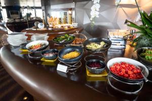 a buffet with many bowls of food on a table at Tower Club at lebua in Bangkok