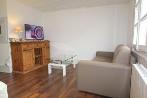 a living room with a couch and a table at L'Appartement - Cœur de Riquewihr - 2 à 4 personnes in Riquewihr