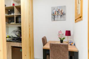 a dining room with a table and a kitchen at SPA apartman Tomin adults only in Soko Banja