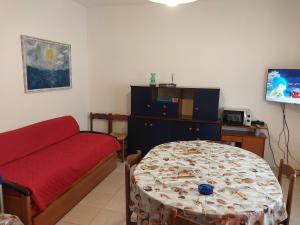 a living room with a couch and a table at Flavia Flats in Bibione