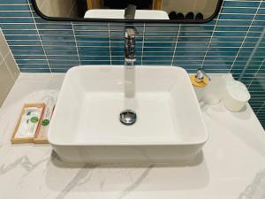 a white sink sitting on top of a bathroom counter at Hải Tiến Be Home in Hoằng Hóa
