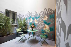 a room with a table with flowers on a wall at Agora' - Boutique Stays in Turin