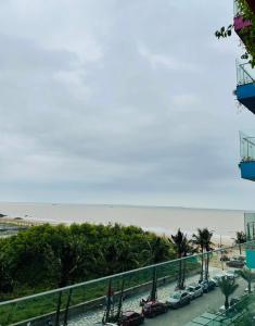a view of the beach from the balcony of a building at Hải Tiến Be Home in Hoằng Hóa