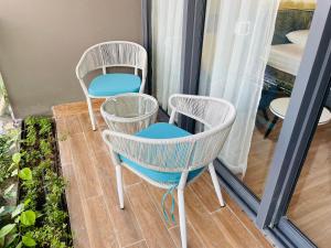 a couple of chairs sitting on a balcony at Hải Tiến Be Home in Hoằng Hóa