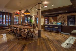 a restaurant with a table and chairs and a bar at The Old No. 77 Hotel & Chandlery in New Orleans