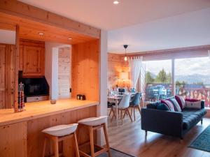 a kitchen and living room with a couch and a table at Apartment Jade 22 by Interhome in Villars-sur-Ollon +42 photos