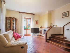 a living room with a couch and a television at Holiday Home Orchidea by Interhome in Camaiore