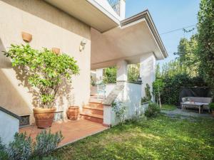 a home with a patio with a potted plant at Holiday Home Orchidea by Interhome in Camaiore