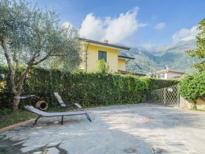 a patio with a bench in front of a house at Holiday Home Orchidea by Interhome in Camaiore