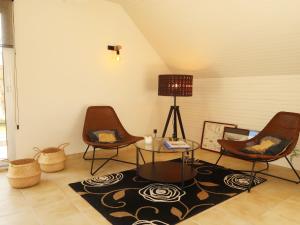 a living room with two chairs and a table at Holiday Home Cremiou Beach by Interhome in Kerlouan