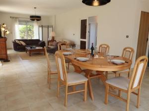 a dining room and living room with a wooden table and chairs at Holiday Home Cremiou Beach by Interhome in Kerlouan +38 photos