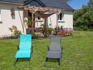two chairs sitting in the grass in front of a house at Holiday Home Ker Jean by Interhome in Plouescat