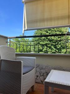 a balcony with two chairs and a table and a window at A Casa di Lu' Elegant Rooms in Monterotondo +40 photos