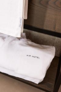 a white pillow with the words are hotel on it at Air Hotel in Karmėlava