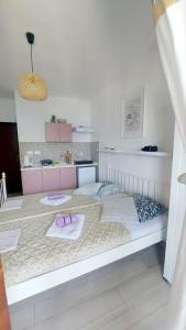 a bedroom with a bed with two slippers on it at Joković Accommodation in Kotor
