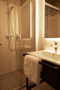 a bathroom with a sink and a shower at Air Hotel in Karmėlava