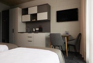 a bedroom with a bed and a table with chairs at Air Hotel in Karmėlava