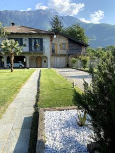 a house with a car parked in front of it at Casa Le Scese Porta di Valtellina in Piantedo