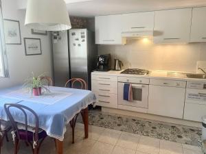 a kitchen with a table and a refrigerator at Casa Lovisoni in Cervignano del Friuli