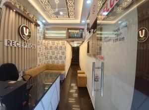 a corridor of a store with a reception desk and a lobby at Hotel Shree Balaji in Ujjain +12 photos