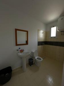 a bathroom with a sink and a toilet at Sunny Rentals in Vlorë