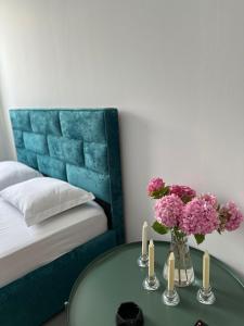 a room with a table with flowers and candles at Sunny Rentals in Vlorë