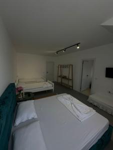 a room with two beds and a tv in it at Sunny Rentals in Vlorë