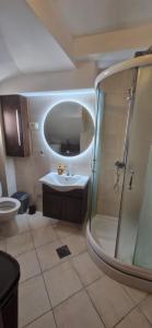 a bathroom with a shower and a sink at Chic apartment in the City Center by the sea in Tivat +12 photos