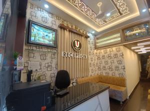 a reception room with a television on a wall at Hotel Shree Balaji in Ujjain