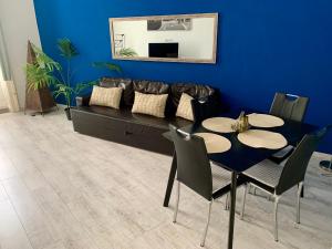 a dining room with a couch and a table and chairs at Dob street cute condo in Budapest