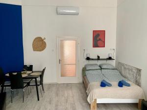 a bedroom with a bed and a table and a dining room at Dob street cute condo in Budapest