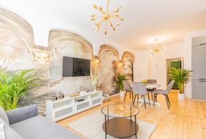 a living room with a couch and a table at Apartament Podkoziołek Stary Rynek in Poznań