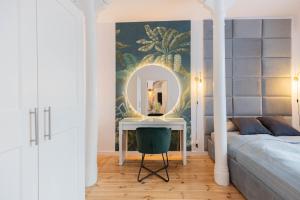 a bedroom with a mirror and a bed and a desk at Apartament Podkoziołek Stary Rynek in Poznań