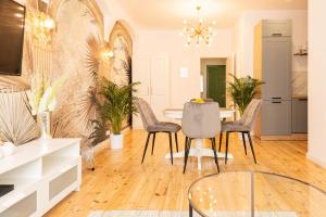 a dining room with a table and chairs at Apartament Podkoziołek Stary Rynek in Poznań +29 photos