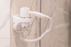 a white phone is hanging on a wall at Apartament Podkoziołek Stary Rynek in Poznań