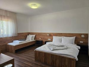 a bedroom with two beds and a couch at Hostel PREMIUM in Derventa