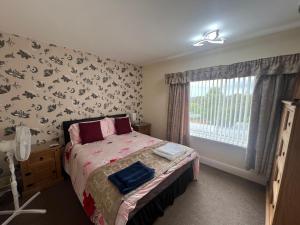 a bedroom with a bed and a window at The Northdale Hotel Ltd in Skegness