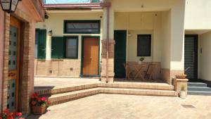 a home with stairs and a door with green shutters at Casa Lamberti B&B in Cava deʼ Tirreni