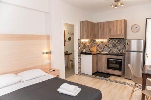 a bedroom with a large bed and a kitchen at Antonia's Apartments in Kassiopi