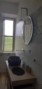 a bathroom with a blue sink and a mirror at Enjoy Sunset in Colle Massari