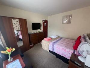 a hotel room with a bed and a mirror at The Northdale Hotel Ltd in Skegness