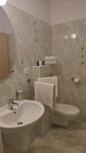 a bathroom with a white sink and a toilet at apartmány Marco Shipping in České Budějovice