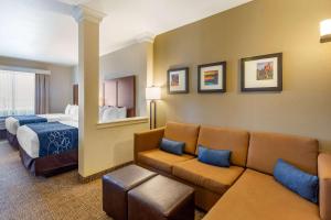 a hotel room with a couch and a bed at Comfort Suites Near Denver Downtown in Denver +64 photos