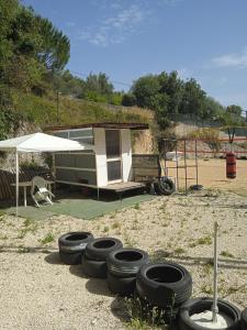 a group of tires sitting in front of a trailer at AREA MULTISPORT Camping & Camper in Canicattini Bagni