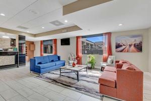 a living room with two blue couches and a table at Quality Inn in Dalton