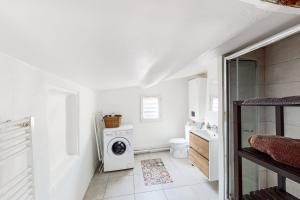 y baño blanco con lavadora. en Le Pǐgeonnier - Un Voyage En Provence, en Aix-en-Provence 1 foto más