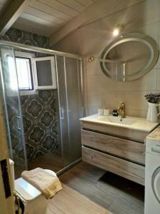 a bathroom with a shower and a sink at Mountain Breeze Cottage in Makriótika +30 photos