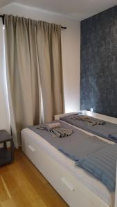 a bedroom with two beds with towels on them at Royal Villa - HAWAII in Vrnjačka Banja