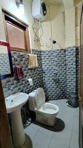 a bathroom with a toilet and a sink at Riwar Homestay in Mawlynnong +9 photos