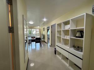a room with white shelves and a dining room at Phuket Town Condo 2 Bedroom with Balcony-Cats Friendly in Phuket Town